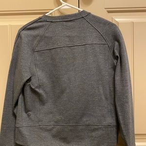 A dark grey lululemon fitted sweatshirt.